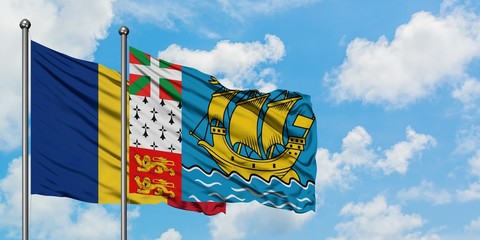 Romania and Saint Pierre And Miquelon flag waving in the wind against white cloudy blue sky...