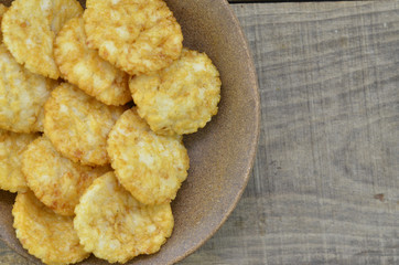 Plate of rice cracker on wooden background