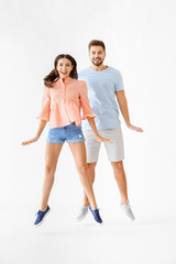 Obraz premium Portrait of jumping young couple on white background