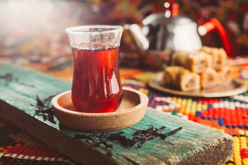 delicious turkish tea and baklava on colorful rug - obrazy, fototapety, plakaty