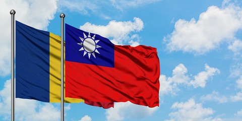 Romania and Taiwan flag waving in the wind against white cloudy blue sky together. Diplomacy concept, international relations.