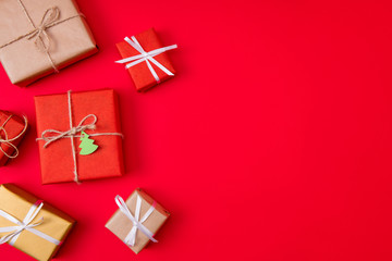 Photo of creative concept of new year preparation gift boxes next empty space isolated red vibrant color background