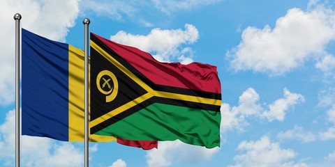 Romania and Vanuatu flag waving in the wind against white cloudy blue sky together. Diplomacy concept, international relations.