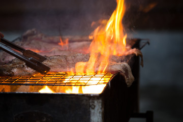 Roast pork on a charcoal flame.