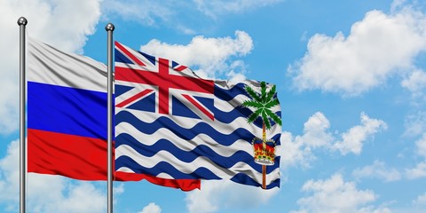 Russia and British Indian Ocean Territory flag waving in the wind against white cloudy blue sky together. Diplomacy concept, international relations.