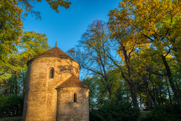 Naklejka premium Rotunda Sv. Mikuláše trees around fall colored with sunrise