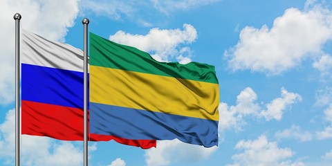 Russia and Gabon flag waving in the wind against white cloudy blue sky together. Diplomacy concept, international relations.