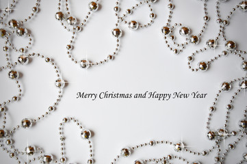 Silver beads for interior decoration on a white background. Decorations for the holiday. merry Christmas and happy New year.