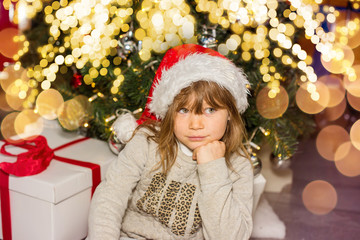 beautiful girl waiting impatiently for the opening of gifts