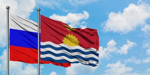 Russia and Kiribati flag waving in the wind against white cloudy blue sky together. Diplomacy concept, international relations.