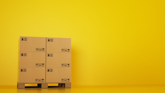Pile of cardboard boxes on a wooden pallet with yellow background