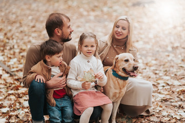 Happy family: mother, father, children son, daughter and dog labrador walking and have fun in park. Warm memories. Relations Love Generation lifestyle concepts. Family traditions