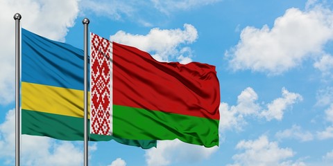 Rwanda and Belarus flag waving in the wind against white cloudy blue sky together. Diplomacy concept, international relations.
