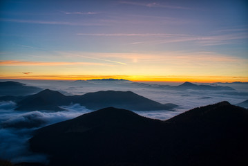 Mist flood the valley and mountains at the beautiful sunrise, slovakia, great rozutec