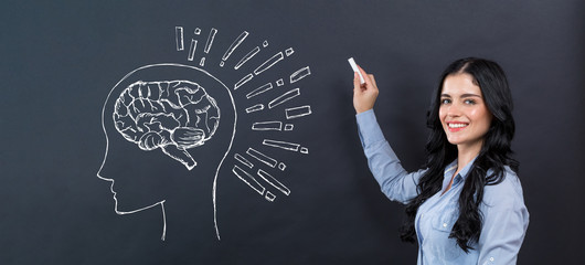 Brain illustration with young woman writing on a blackboard