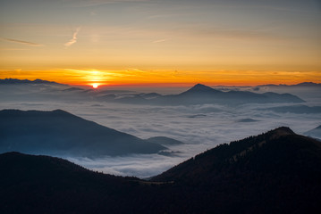 Mist flood the valley and mountains at the beautiful sunrise, slovakia, great rozutec