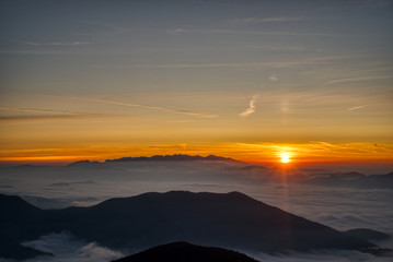 Mist flood the valley and mountains at the beautiful sunrise, slovakia, great rozutec
