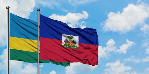 Rwanda and Haiti flag waving in the wind against white cloudy blue sky together. Diplomacy concept,...