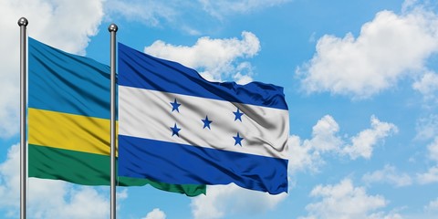 Rwanda and Honduras flag waving in the wind against white cloudy blue sky together. Diplomacy concept, international relations.