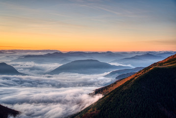 Mist flood the valley and mountains at the beautiful sunrise, slovakia, great rozutec