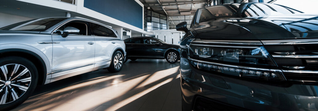 Brand new cars at dealer showroom. Perfectly polished. Natural lighting