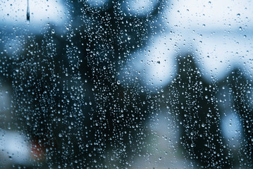 Waterdrops on the clean glass. Window and rainy day. Close up view