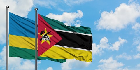 Rwanda and Mozambique flag waving in the wind against white cloudy blue sky together. Diplomacy concept, international relations.