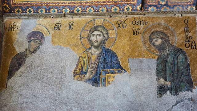 13th century Deesis Mosaic of Jesus Christ flanked by the Virgin Mary and John the Baptist in the Hagia Sophia temple in Istanbul, Turkey.