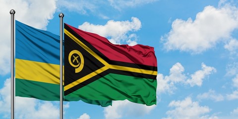 Rwanda and Vanuatu flag waving in the wind against white cloudy blue sky together. Diplomacy concept, international relations.