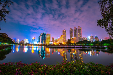 View of the Park in the night,Beautiful reflection of skyscrapers on Chao Phraya River Amazing night life in Bangkok city,Thailand.