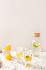 Tasty fresh lemonade on white table