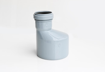 Plastic PVC pipes sewer fittings on a light background.