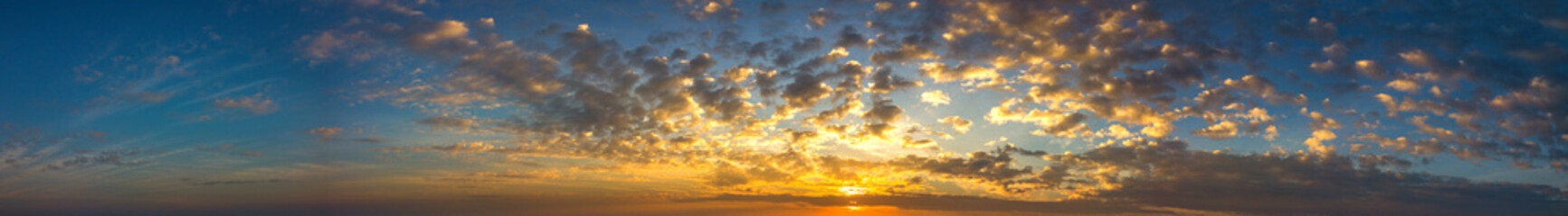 Naklejka na ściany i meble Panorama Sunlight with dramatic sky. Cumulus sunset clouds with sun setting down on dark background.Vivid orange cloud sky.