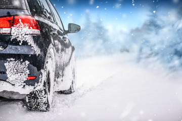 Car in winter on snowy road. Speed snow cars background with mountains. © Milan