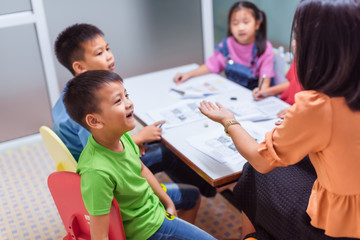 Asian elementary school children are studying in the classroom.
