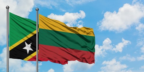 Saint Kitts And Nevis and Lithuania flag waving in the wind against white cloudy blue sky together. Diplomacy concept, international relations.
