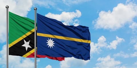 Saint Kitts And Nevis and Nauru flag waving in the wind against white cloudy blue sky together. Diplomacy concept, international relations.