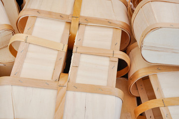 A vintage style abstract shows environmentally friendly 6 quart wooden fruit baskets waiting to be...