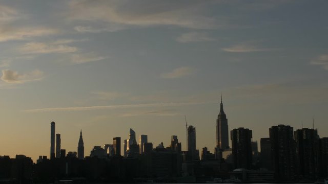 dark manhattan skyline handheld slow motion shot from a boat at the end of the day