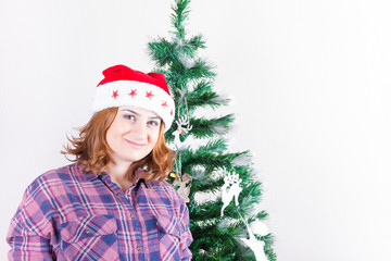 Portrait of a pregnant girl in a Santa hat