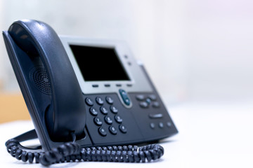 close up telephone VOIP technology standing on office desk in office room with copy space white...