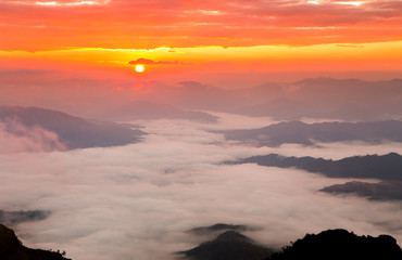 Fototapeta na wymiar Colorful color sky with sea of mist and cloud and silhouette mountains at dawn time before sunrise, take photo from top of mountain in Thailand