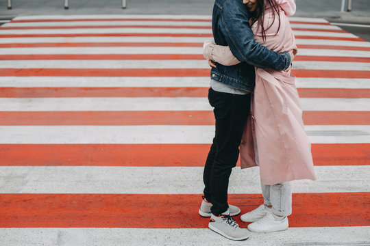 Cut View Of Man And Woman Stand On Crosswalk And Hug Each Other. Say Goodbye. Split. Alone Outside. Sad And Upset.