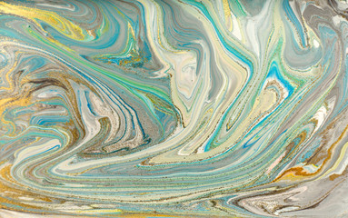 Pale blue marble pattern with golden glitter. Abstract liquid background.