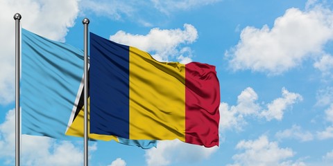 Saint Lucia and Chad flag waving in the wind against white cloudy blue sky together. Diplomacy concept, international relations.
