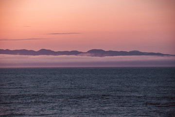 View of Vancouver Island from Port Angeles: the famous Washington State mist on the sea, with mountains in the background. Soft, romantic scenery.