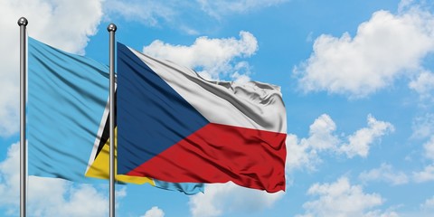 Saint Lucia and Czech Republic flag waving in the wind against white cloudy blue sky together. Diplomacy concept, international relations.