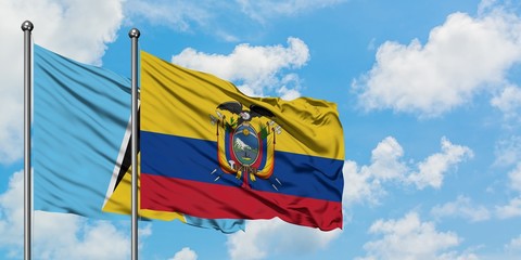 Saint Lucia and Ecuador flag waving in the wind against white cloudy blue sky together. Diplomacy concept, international relations.