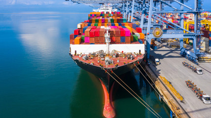 Container ship carrying container box at industrial port in import export business logistic and...