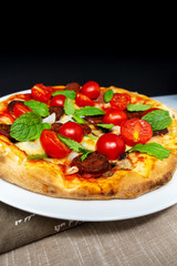 Sausage Pizza with Ham and tomatoes